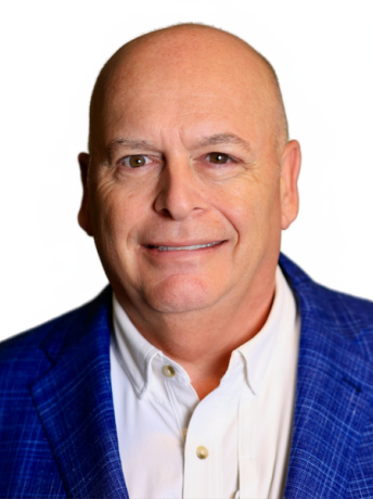 Guy Legare in a white button down shirt and blue sport coat