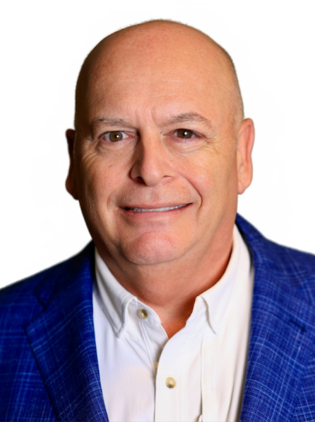 Guy Legare in a white button down shirt and blue sport coat