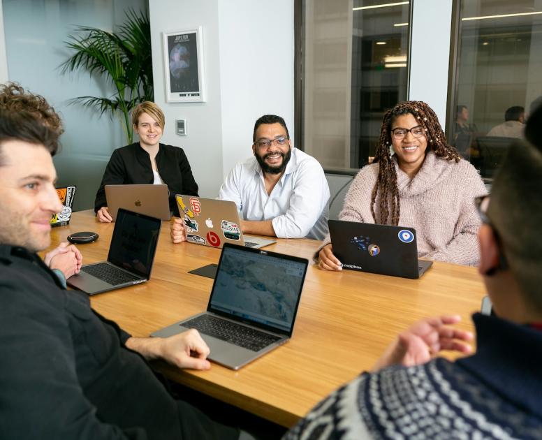Smiling people gathering in conference room